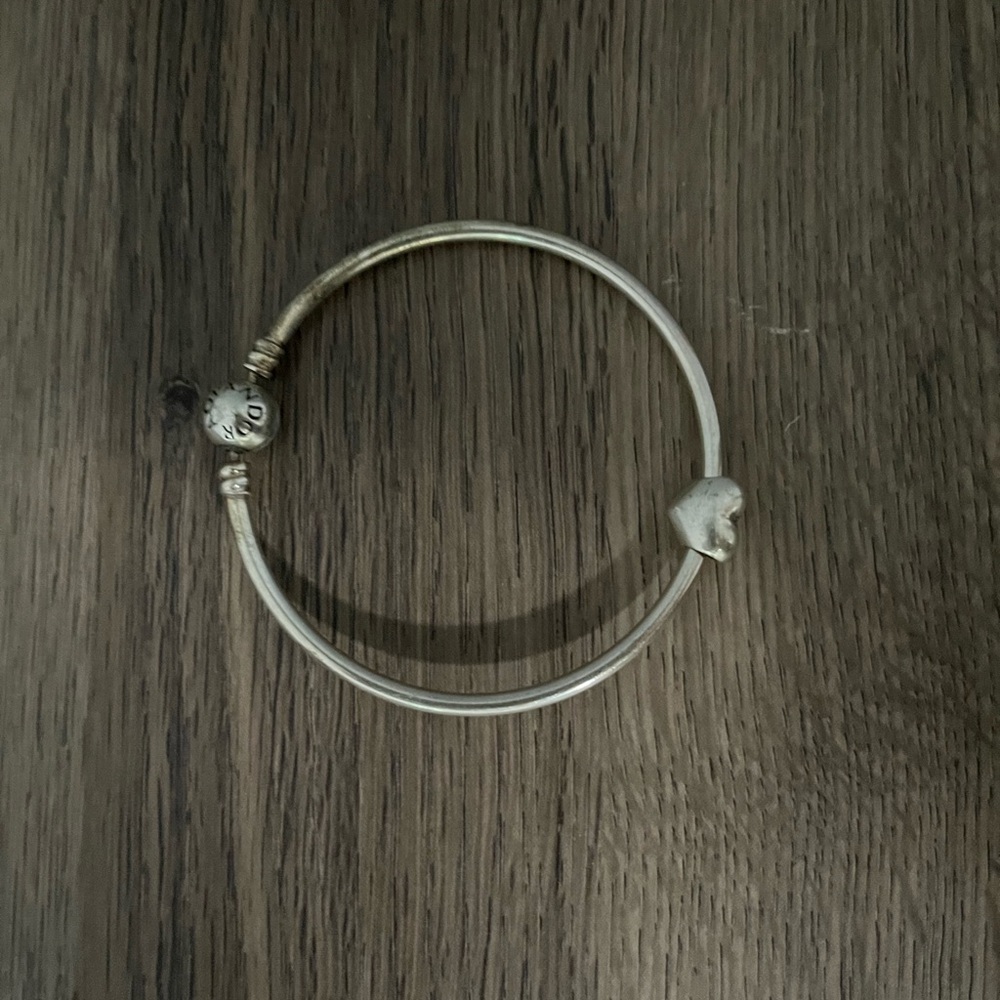 Silver pandora bracelet with heart charm.